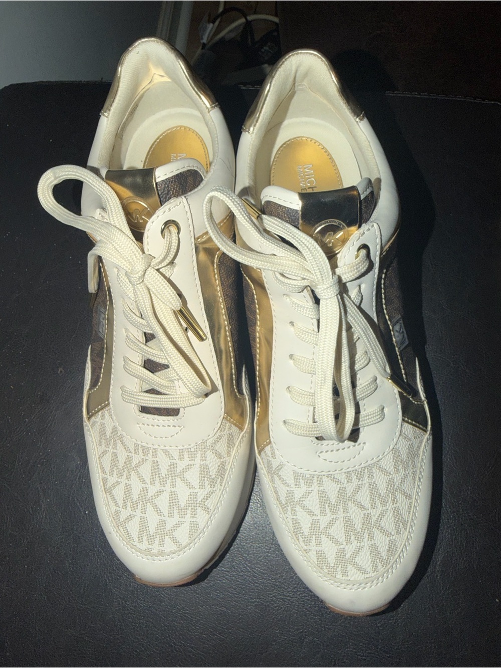 e Michael Kors Maddy Mixed-Media Trainer sneakers in a vanilla, brown, and metal